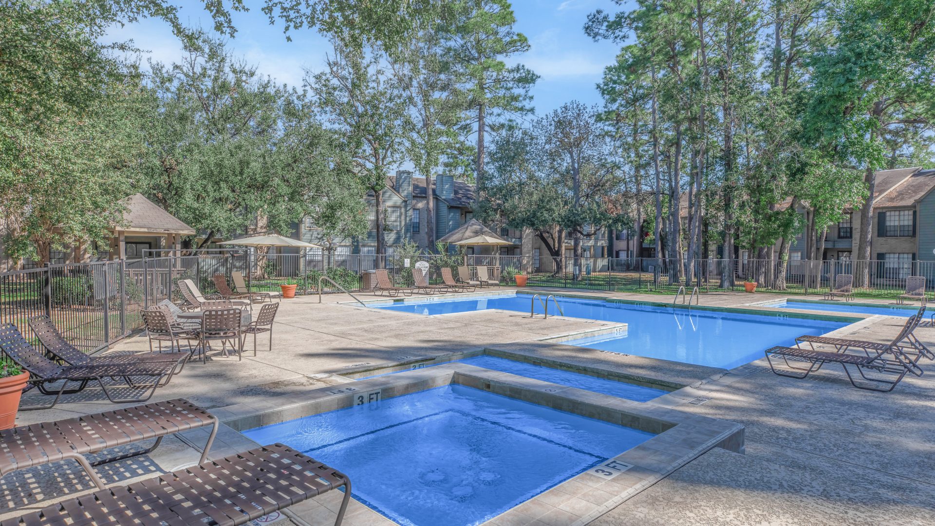 a pool with a pool table and chairs in it